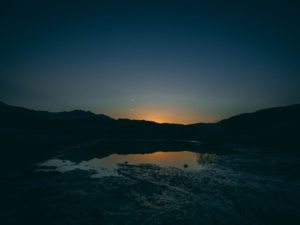 silhouette of mountain near body of water