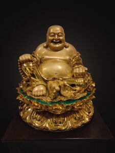 gold buddha figurine on black surface