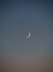 white crescent moon in the sky